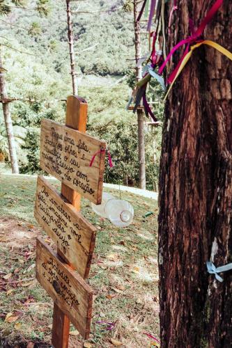 a sign in a forest next to a tree at Plaza Caldas da Imperatriz Resort & Spa in Santo Amaro da Imperatriz