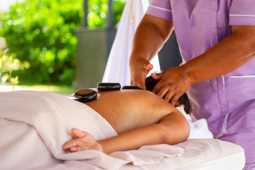 a woman in a spa receiving a back massage at Cancun Bay Resort - All Inclusive in Cancún
