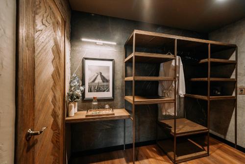 a walk in closet with wooden shelves and a door at CASA LUCIANA Condesa in Mexico City
