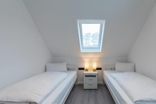 En eller flere senge i et værelse på Langeneß