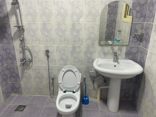 a bathroom with a toilet and a sink at Admire Apart Hotel - 1 in Abu Arish