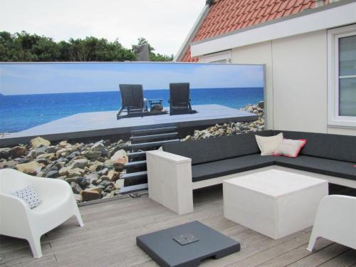 a patio with a mural of the ocean at Luxury apartment in Koudekerke with sauna in Koudekerke