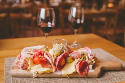 a plate of food with two glasses of wine at Bemar Carmelo Hotel in Carmelo