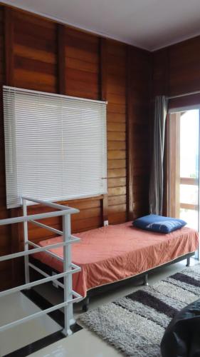 1 dormitorio con 1 cama en una habitación con ventana en MarLuar Casa, en Penha