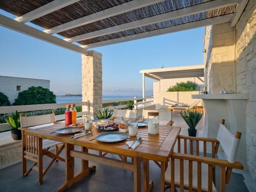 a wooden table on the balcony of a house at Empire Luxury Villas in Santa Maria