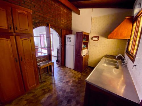 a kitchen with a sink and a refrigerator at Casa Ibañez in Villa Gesell