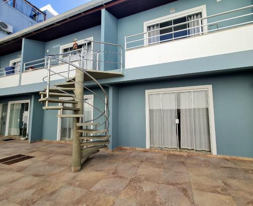 un edificio azul con una escalera de caracol en su lateral en Residencial Praia Brava Blue - Apartamentos, en Balneário Camboriú