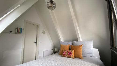 a bedroom with a bed with pillows on it at Wald-Chalet Vulkaneifel in Kerschenbach