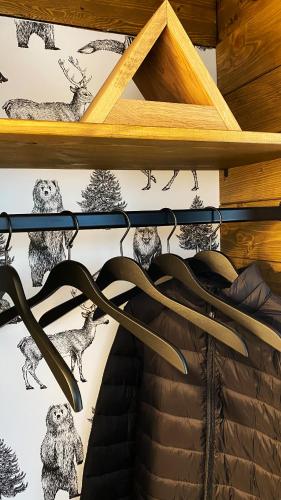 a group of weapons on a wooden shelf at Wald-Chalet Vulkaneifel in Kerschenbach