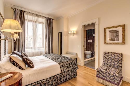 a hotel room with a bed and a chair at Via Napoli Apartments in Rome