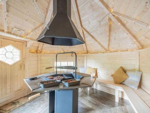 a kitchen with a stove in a sauna at Treetops Luxury Log Cabin - Hot tub, BBQ & Sauna in Kippford