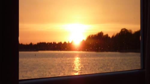 a sunset over a large body of water at Hausboot LAGOON in Stralsund