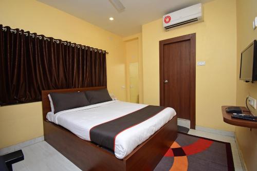 a bedroom with a bed and a television in it at Gokul Residency Near Emami City Nager bazar in Dum Dum