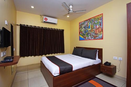 a bedroom with a bed and a television in it at Gokul Residency Near Emami City Nager bazar in Dum Dum