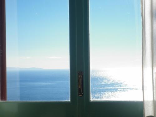 an open door with a view of the ocean at Fico D'India Relais in Furore