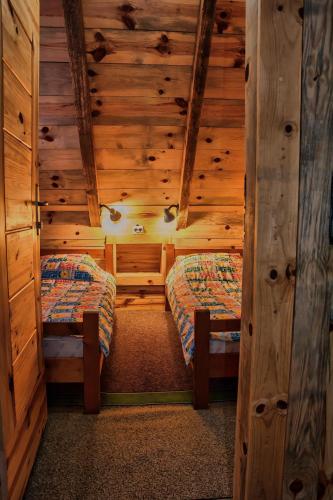 a room with two beds in a log cabin at Apartments Life in Kolašin
