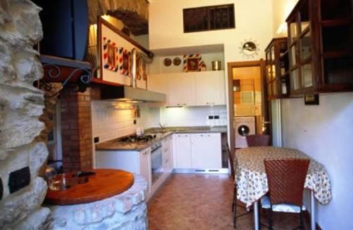 a kitchen with a table and a dining room at Sandra Villa Rooms in Corniglia