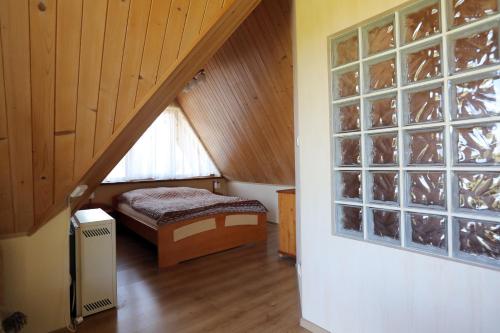 a attic room with a bed and a window at Willa na Wierszykach 1 in Zakopane