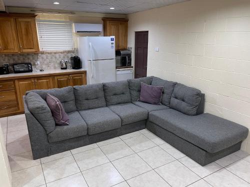 a living room with a couch in a kitchen at Arlene's Nest Diego Martin - 3 Bedroom 1 & half bath Cozy Apt in Diego Martin