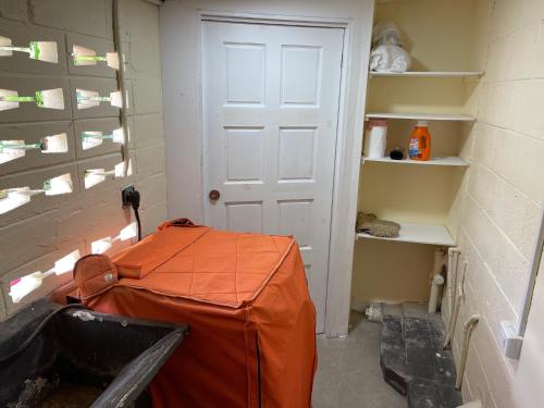 a room with a white door and an orange tent at Arlene's Nest Diego Martin - 3 Bedroom 1 & half bath Cozy Apt in Diego Martin