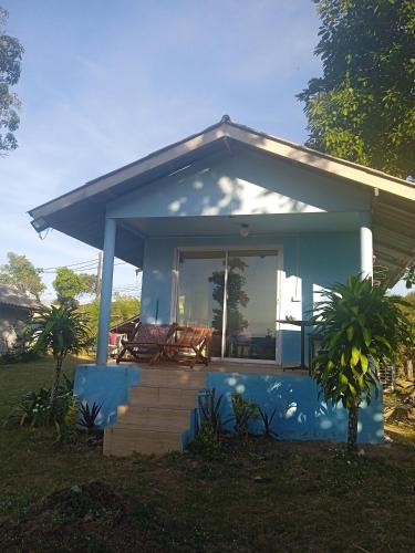 a small blue house with a porch and stairs at Miss You Beach Resort Koh Mak in Ko Mak