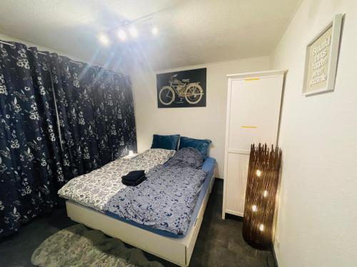 a bedroom with a bed with a motorcycle on the wall at Gracehomes in Herrenberg