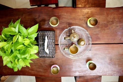 a wooden table with two plates of food on it at Amango Home in Ho Chi Minh City