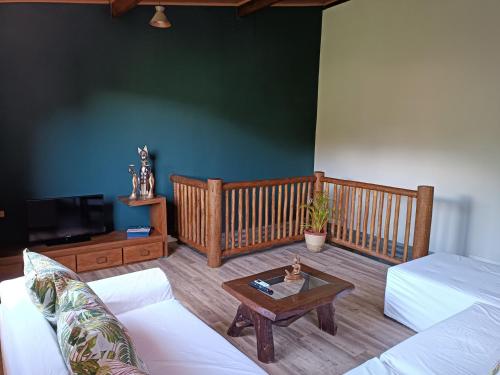 a living room with a couch and a coffee table at Casa da Colina in Trancoso