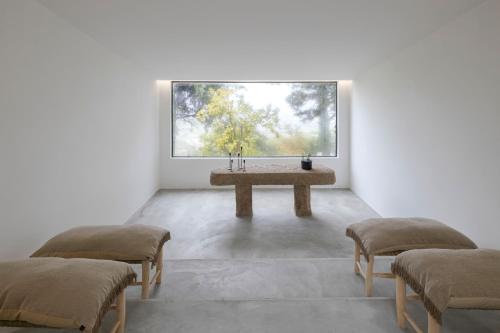 a room with two chairs and a table with a window at TheVagar Countryhouse in Belmonte