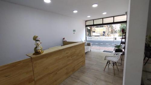 a salon with a counter and a chair in a room at Hotel Boutique Estadio in Medellín