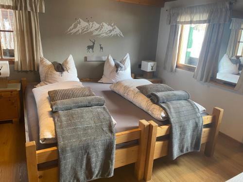 a bedroom with two twin beds with blankets on them at Branderhof in Jochberg