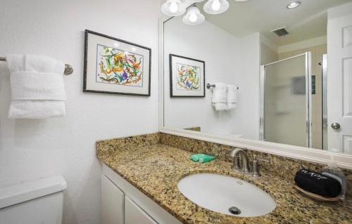 a bathroom with a sink and a mirror at Unobstructed ocean views, Oceanside Pool, 2B/2B, Sleeps 6 in Kailua-Kona