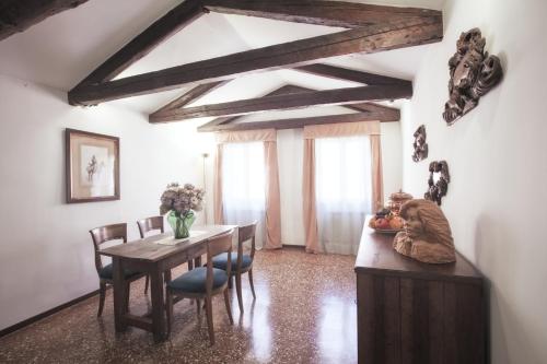 a dining room with a wooden table and chairs at Palazzetto San Lio, Rialto in Venice