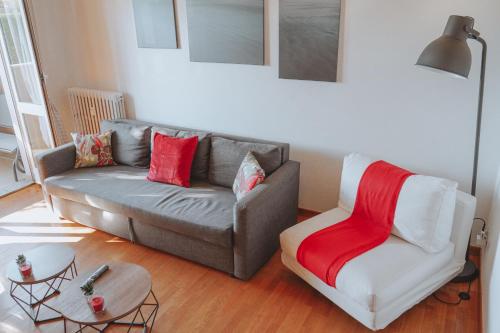 a living room with a couch and a chair at 10 min from the Airport-Wifi-Free Parking in Samarate
