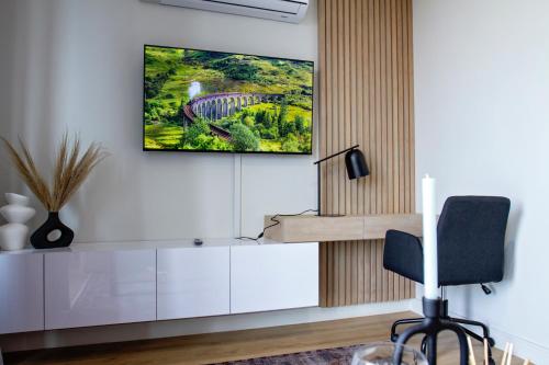 a living room with a tv on the wall at Executive Apartment at Ellipse Waterfall in Midrand