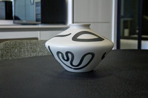 a white vase sitting on top of a table at Executive Apartment at Ellipse Waterfall in Midrand