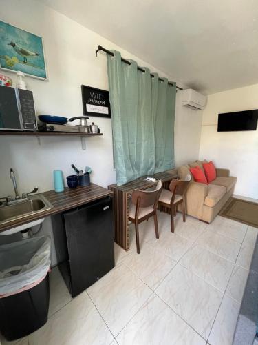 a kitchen and a living room with a couch at Las Olas Beach apartments in Arecibo
