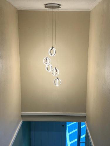 a chandelier hanging from the ceiling in a room at Super 8 by Wyndham Bangor in Bangor