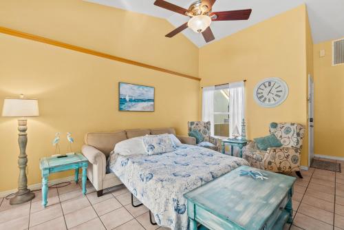 a bedroom with a bed and a ceiling fan at Heart of the Waves - 3BR & 2BA Beach Retreat - NEW HOT TUB - Outside Patio with Grill & Seating, Steps to Fun! in Melbourne