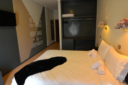 a bedroom with a bed with two towels on it at King Alexander in Florina