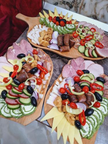 a table topped with three different types of food at Pensiunea Adriana in Vadu Izei
