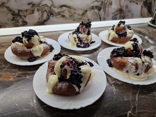 a group of desserts on plates on a table at Pensiunea Adriana in Vadu Izei