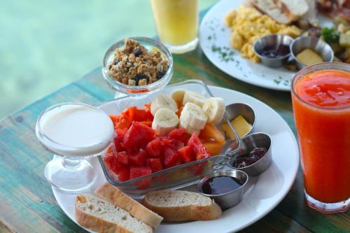 a table with a plate of food with fruit and toast at Gran Hotel Bahia in Bocas del Toro