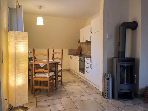 a small kitchen with a table and a stove at NaturApartments - Hideaway & Spa in Burg