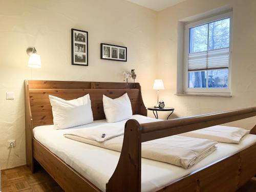 a bedroom with a bed with white pillows and a window at NaturApartments - Hideaway & Spa in Burg