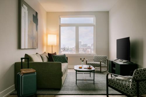 a living room with a couch and a tv at Sonder Ovation in Philadelphia