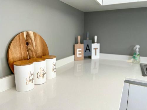 three mason jars sitting on a counter in a kitchen at Langebaan Holiday Home in Langebaan