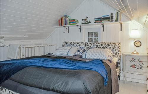 a bedroom with a large bed with a blue blanket at Stunning Home In Arvika With Kitchen in Arvika