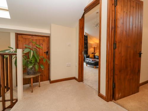 a hallway with a door leading to a living room at The Coach House in Cheltenham