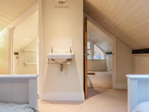 a bathroom with a sink on the wall at Oakhurst in Newton Abbot